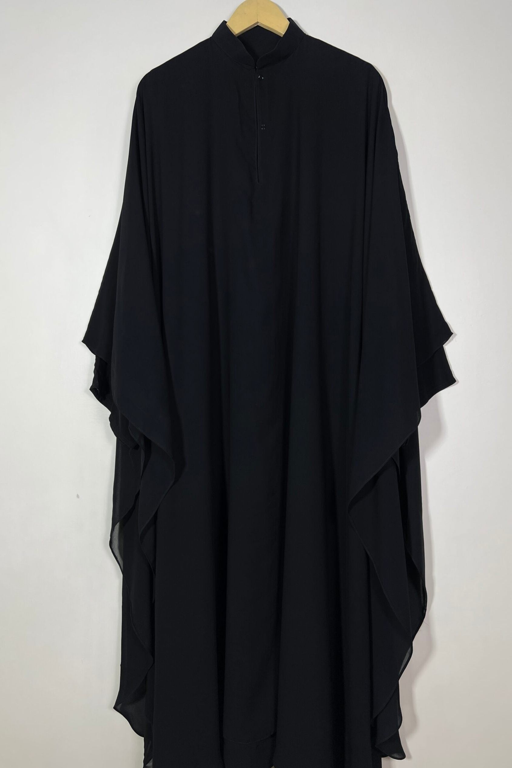 Halimah black front open butterfly abaya hanging on hanger showing double layer chiffon and soft fall