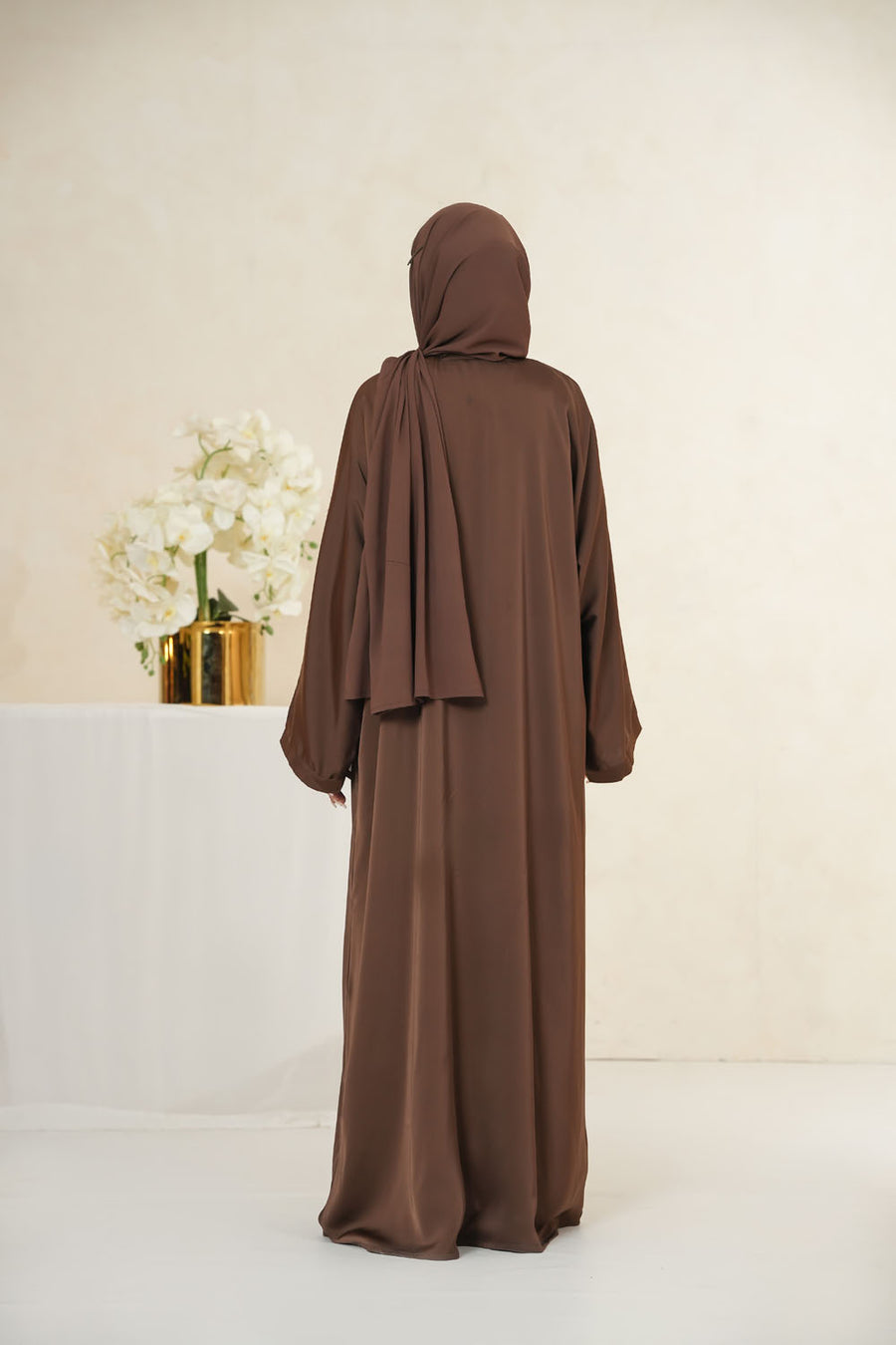 Back full view of Imported TikTok Crinkle Nida Fabric Abaya for women in brown color with elegant flowing drape