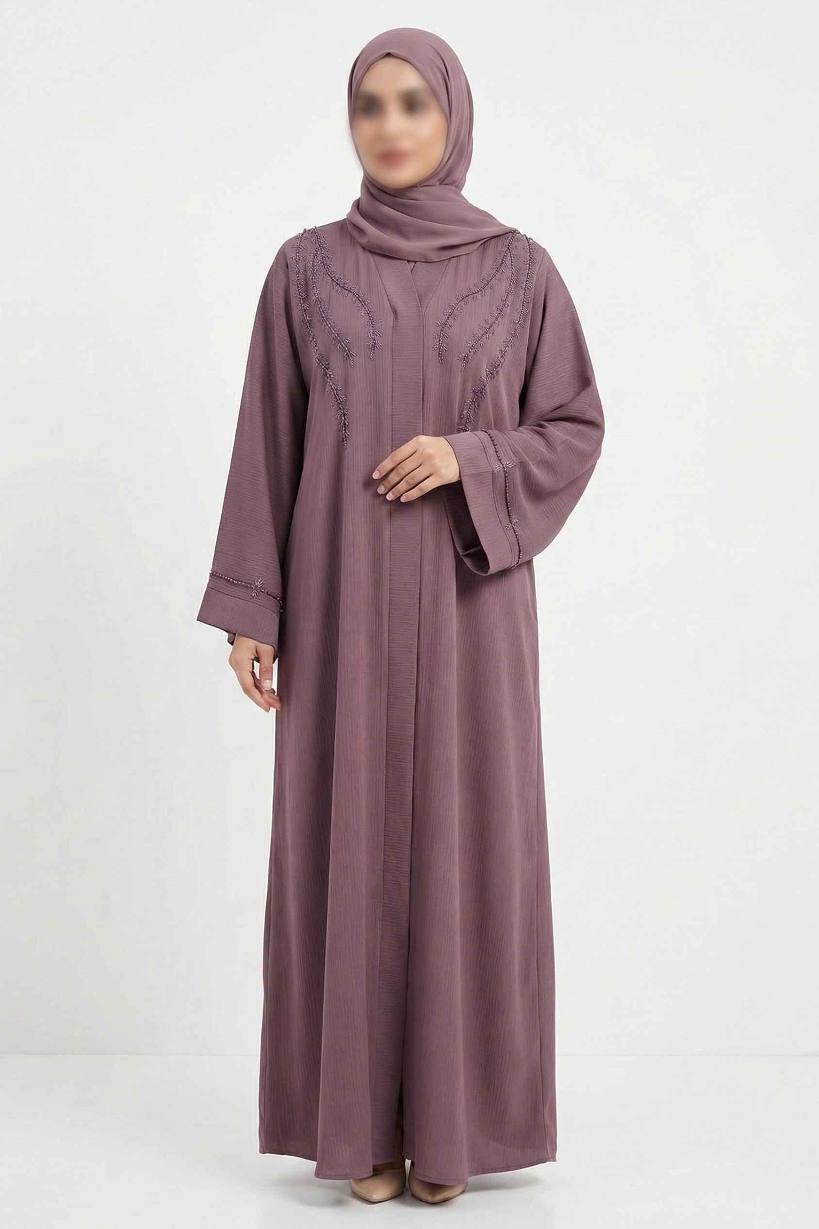 Front full view of soft pink handworked abaya highlighting front open design and delicate bow detailing on sleeves